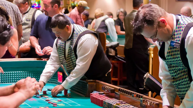 Photo: Antoine Taveneaux (CC BY-SA 3.0) Dealers running a table game for players
